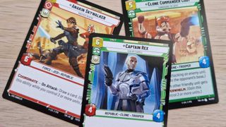 Star Wars Unlimited cards for Anakin Skywalker, Clone Commander Cody, and Captain Rex on a wooden surface