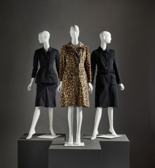 A photo of Carolyn Bessette-Kennedy's three coats, including two in black wool and one cut from faux fur leopard print.