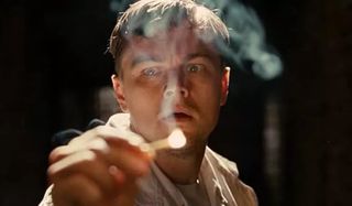 Shutter Island Leonardo DiCaprio lights a match with a horrified face