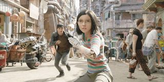 Alita: Battle Angel Alita takes a fighting stance on a sunny Iron City day