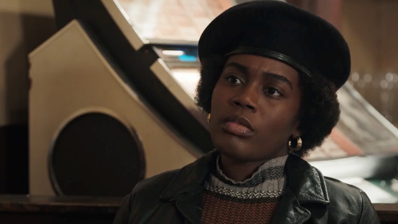 Devin Kessler with a hat on as Afeni Shakur in Godfather of Harlem season 4