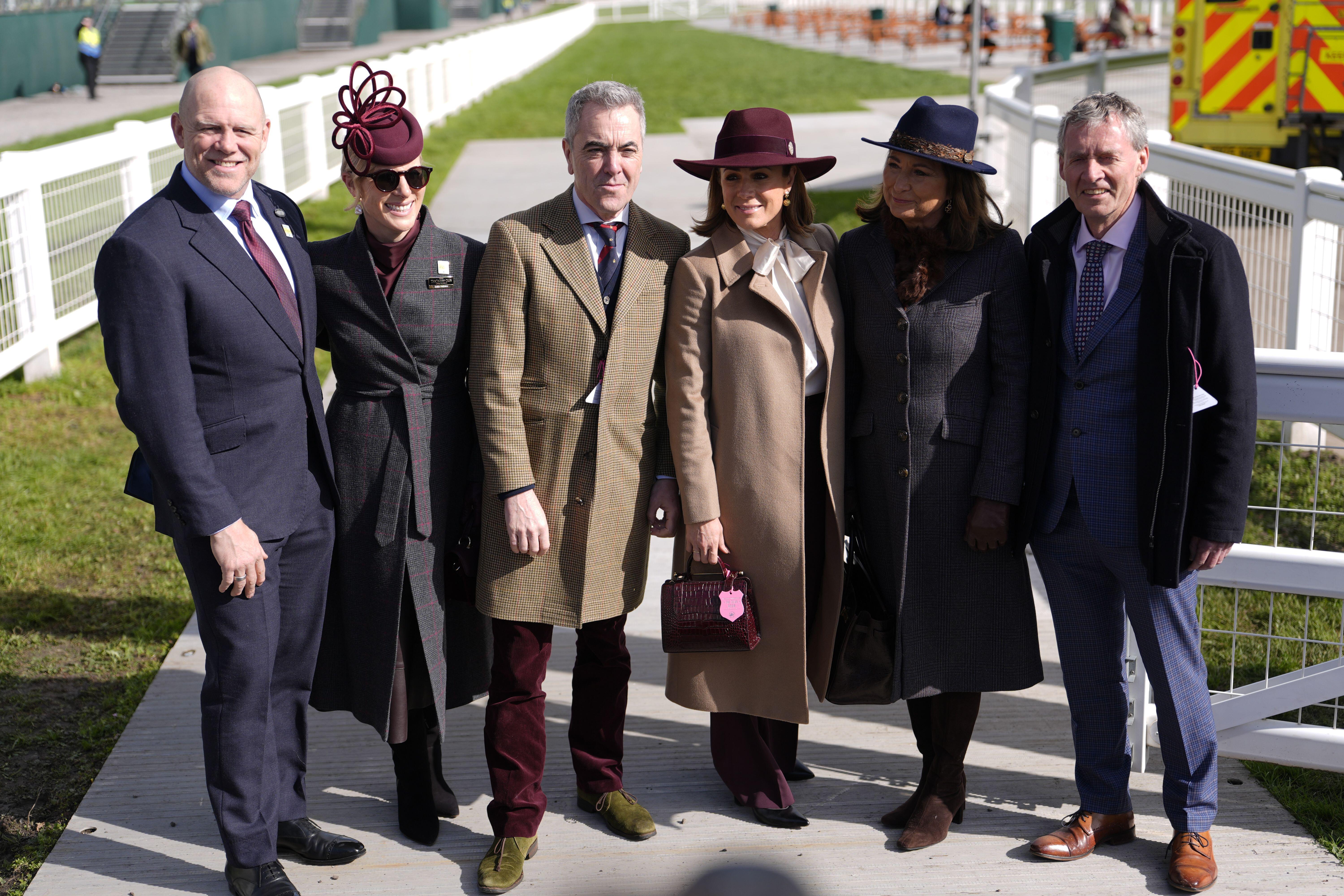 Zara and Mike Tindall posing with Carole Middleton and guests at the Cheltenham race track