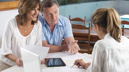 A couple work with a financial planner on their estate planning.