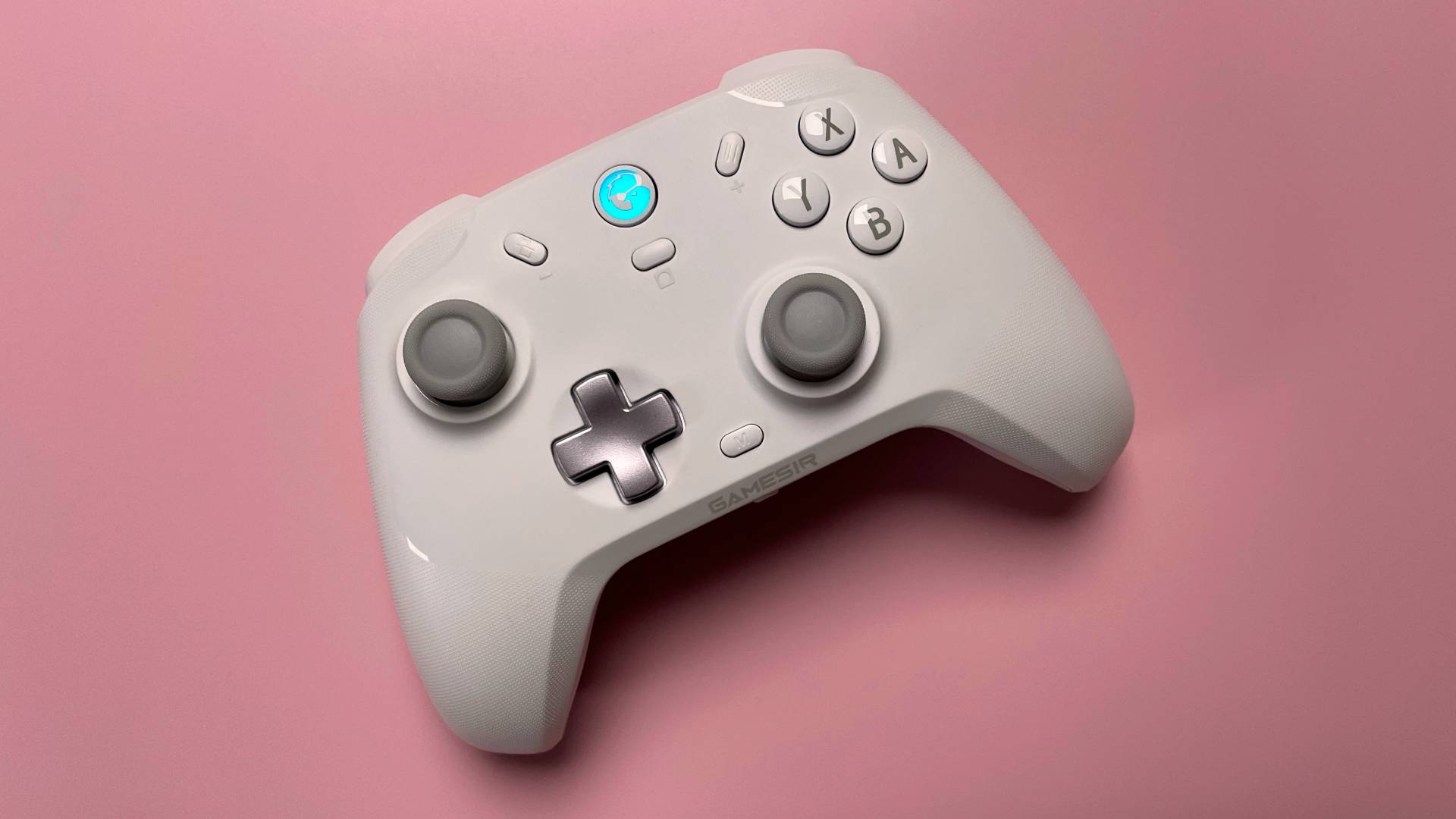 The GameSir T4 Cyclone game controller for iOS and macOS against a pink background.