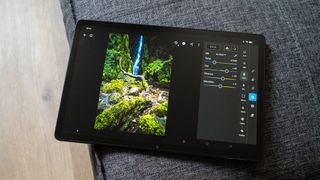 Oppo Pad SE running Adobe Lightroom Mobile on a sofa