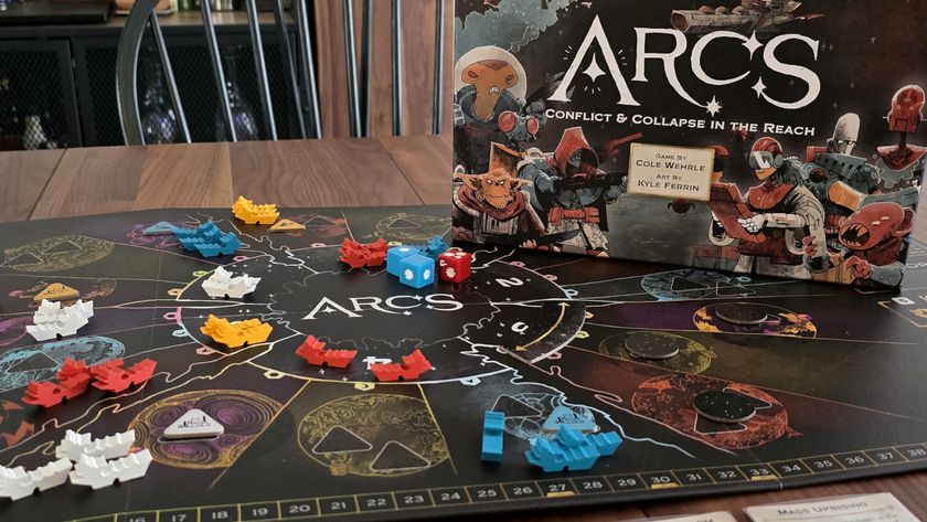 Arcs board game box beside the board, dice, and tokens on a wooden table