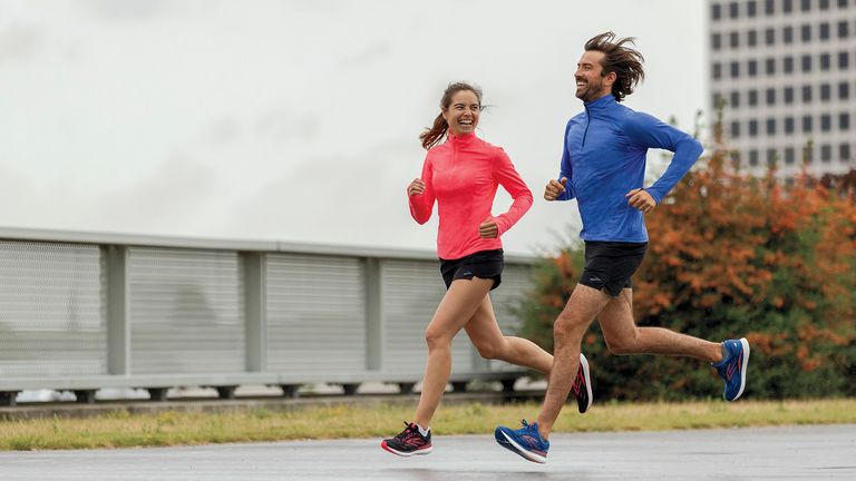 Two people running while smiling