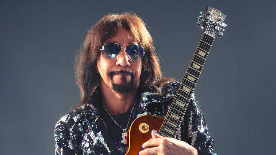 Ace Frehley holding a Les Paul guitar - studio portrait