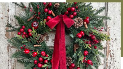 Close up image of a Christmas wreath on a rustic white wooden door.