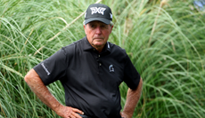 Gary Player watches on with his hands on his hips