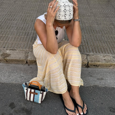 woman wearing yellow pants and black flip flops