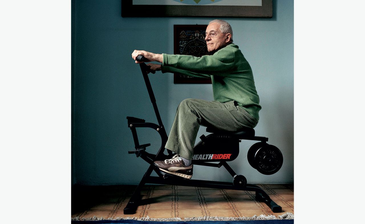 Portrait of Alessandro Mendini on an exercise bike