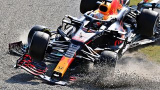 Max Verstappen of the Netherlands driving the (33) Red Bull Racing RB16B Honda and Lewis Hamilton of Great Britain driving the (44) Mercedes AMG Petronas F1 Team Mercedes W12 crash during the F1 Grand Prix of Italy at Autodromo di Monza on September 12, 2021 in Monza, Italy