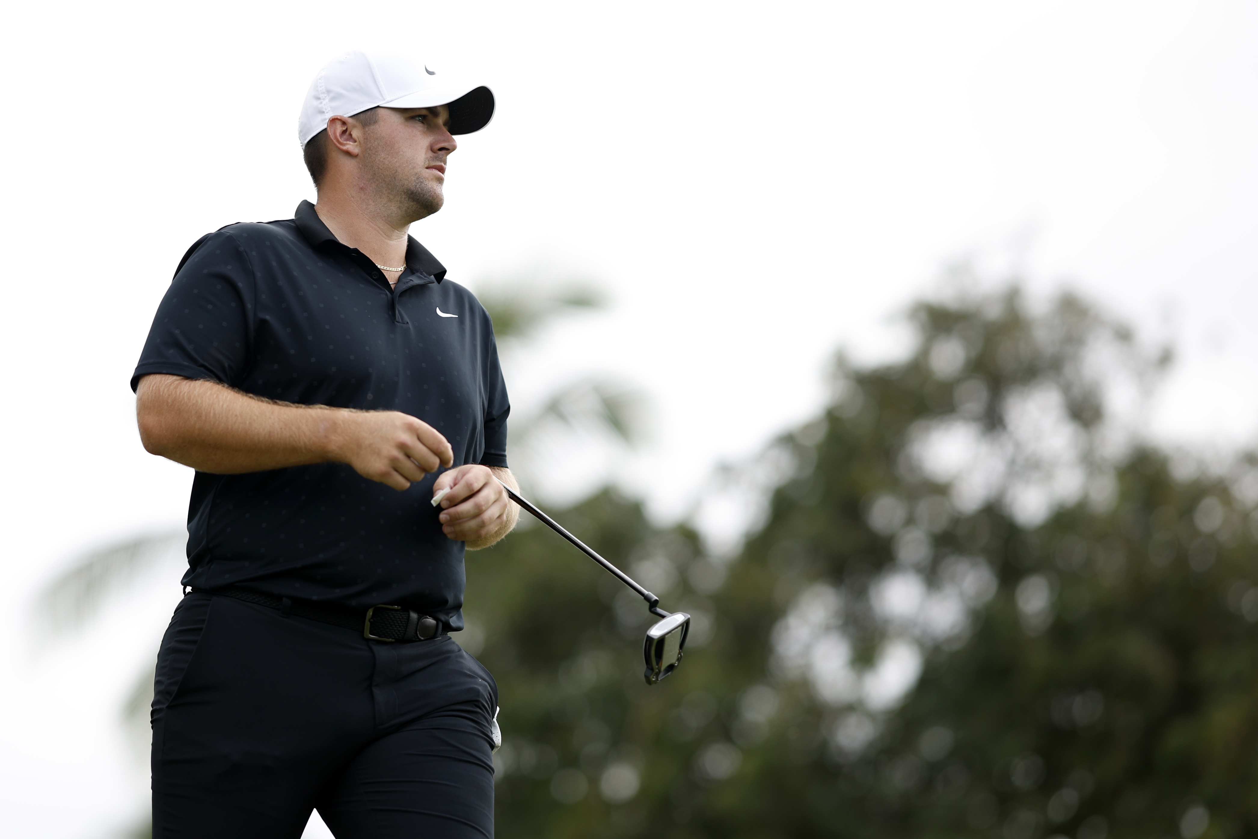 Chris Gotterup walks off the green holding a putter