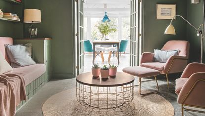 green living room with pink chairs