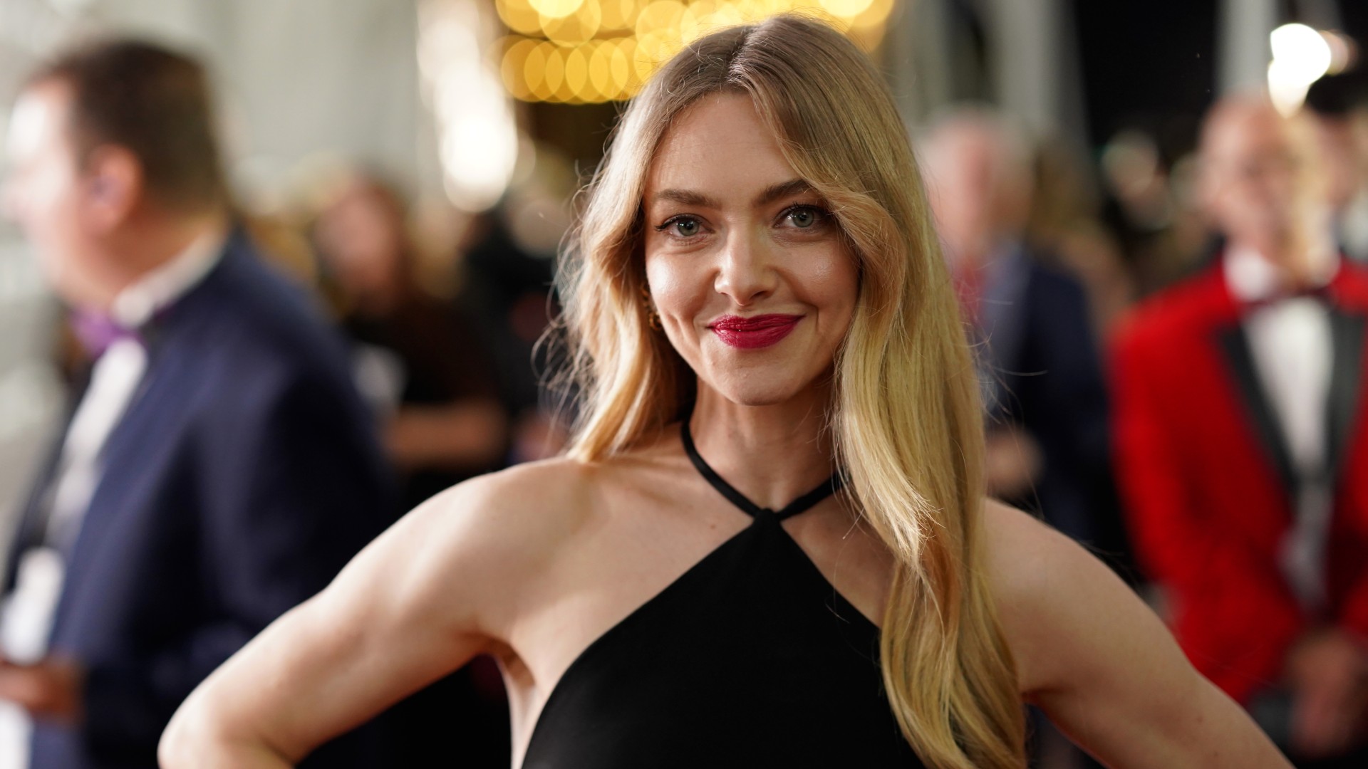 a white woman with blonde hair posing on a red carpet
