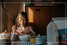 Little girl making her breakfast