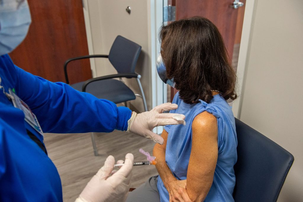 Woman receiving booster shot. 