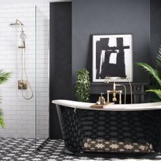 Black and white bathroom with walk-in shower and metallic freestanding bath