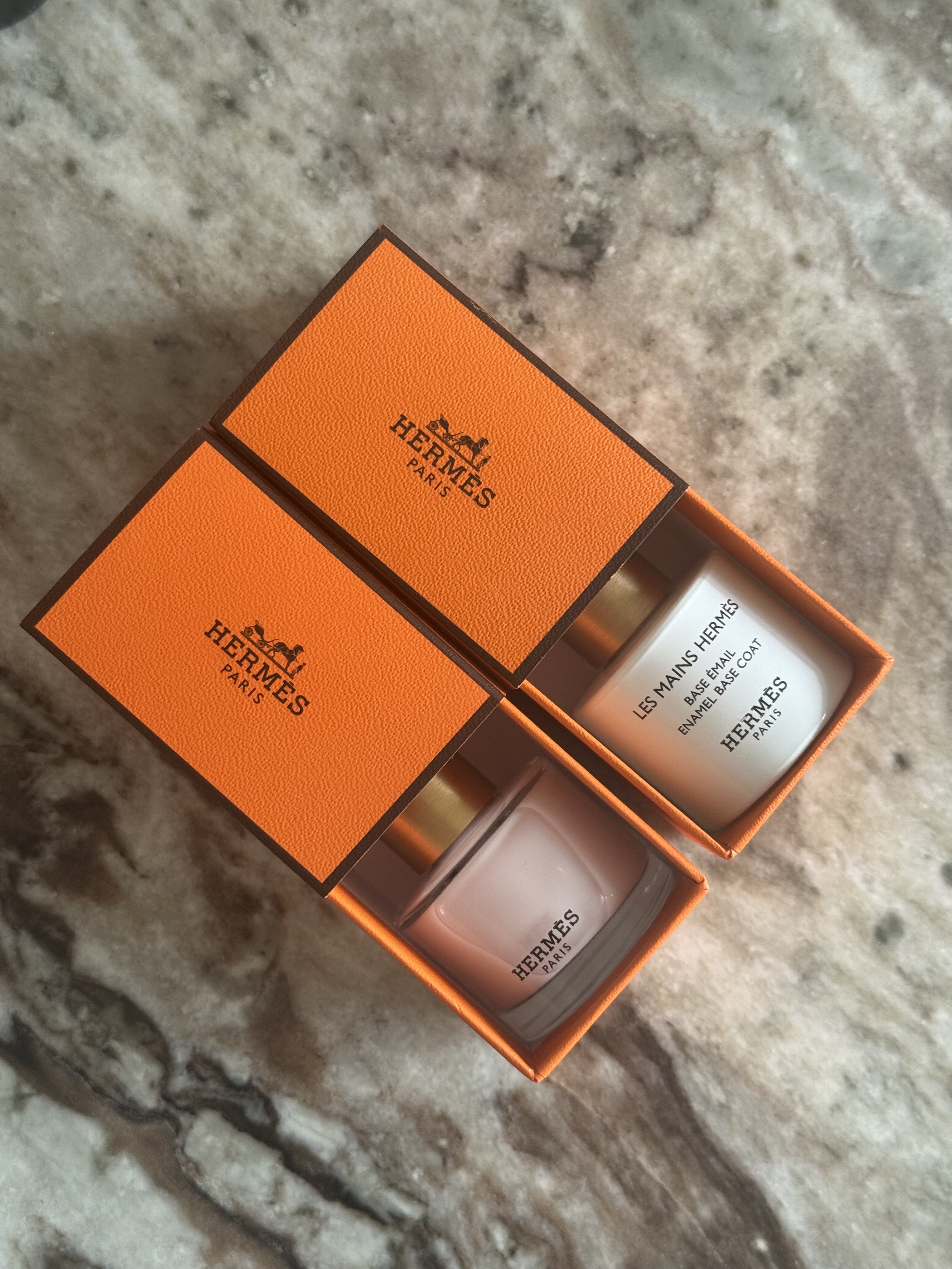 The orange Hermes box packaging for the Hermes Les Mains Hermes nail polishes