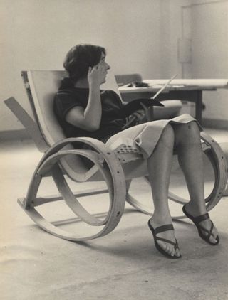 Women sitting on a curved chair
