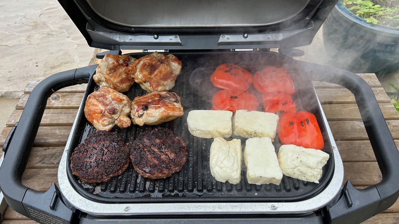 Grilling food on the Ninja Woodfire Outdoor Grill
