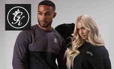 Gym King logo placed over an image of a man and a woman posing together in Gym King outfits