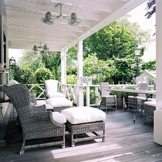 balcony with starch-creamy white cushions table and chair and tree