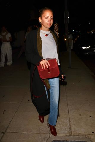 Nicole Richie styles a burgundy bag.