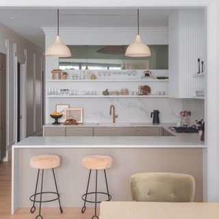 Kitchen with white marble worktops and open shelving