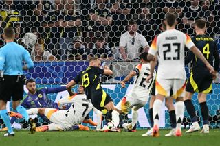 Scotland's defender #15 Ryan Porteous (L) fouls Germany's midfielder #21 Ilkay Gundogan during the UEFA Euro 2024 Group A football match between Germany and Scotland at the Munich Football Arena in Munich on June 14, 2024. (Photo by Fabrice COFFRINI / AFP) (Photo