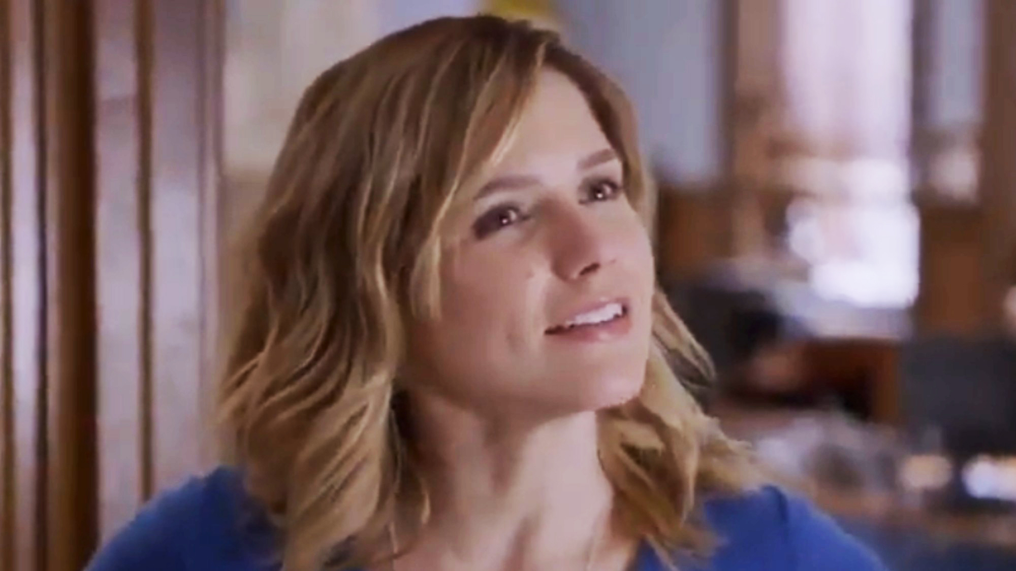 A close up of Sophia Bush smiling in a blue top on Chicago P.D. 