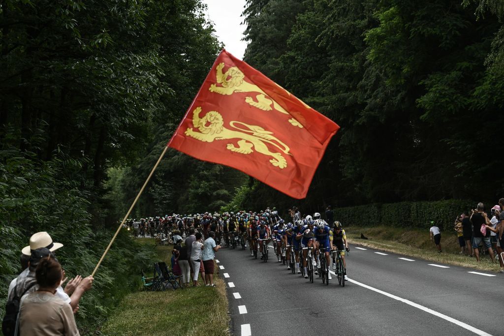 A fan waves the flag of Normandie