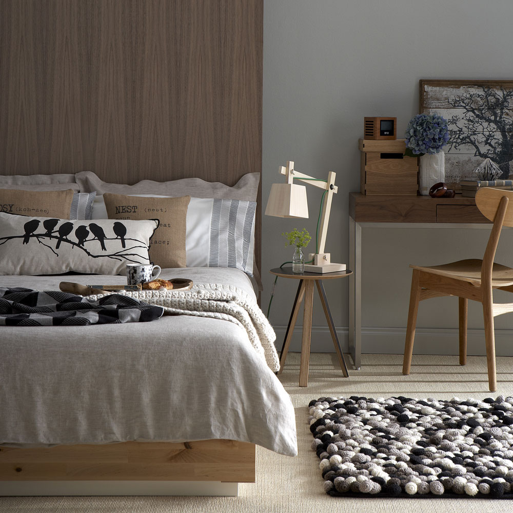 warm and cosy bedroom with wood headboard