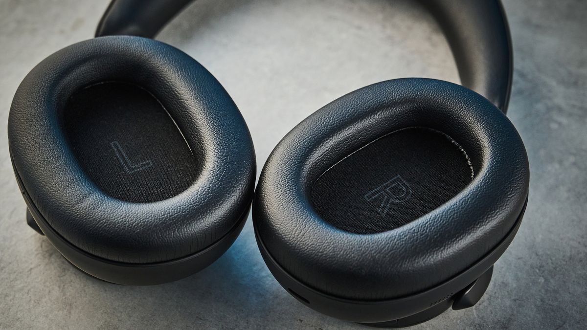 the technics eah-a1000 headphones with a gold technics logo photographed against a blue background