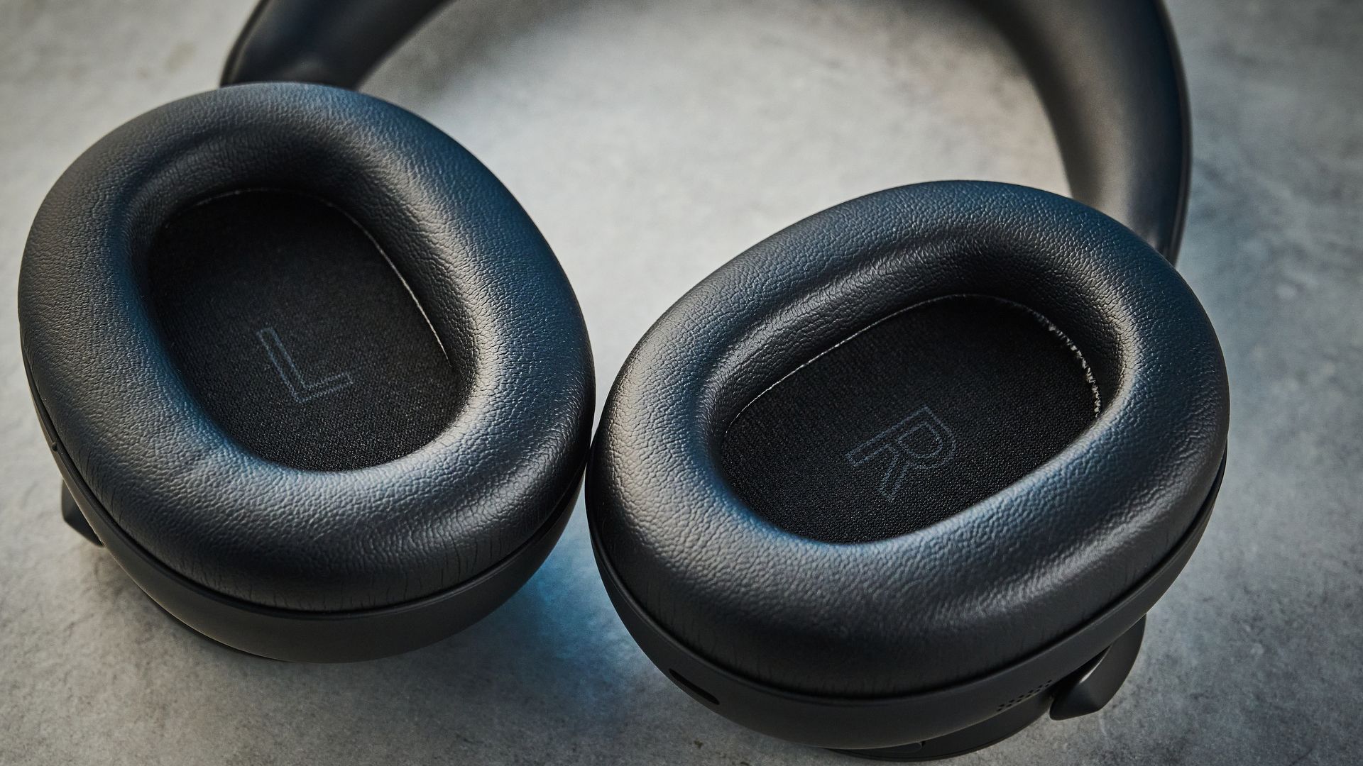 the technics eah-a1000 headphones with a gold technics logo photographed against a blue background