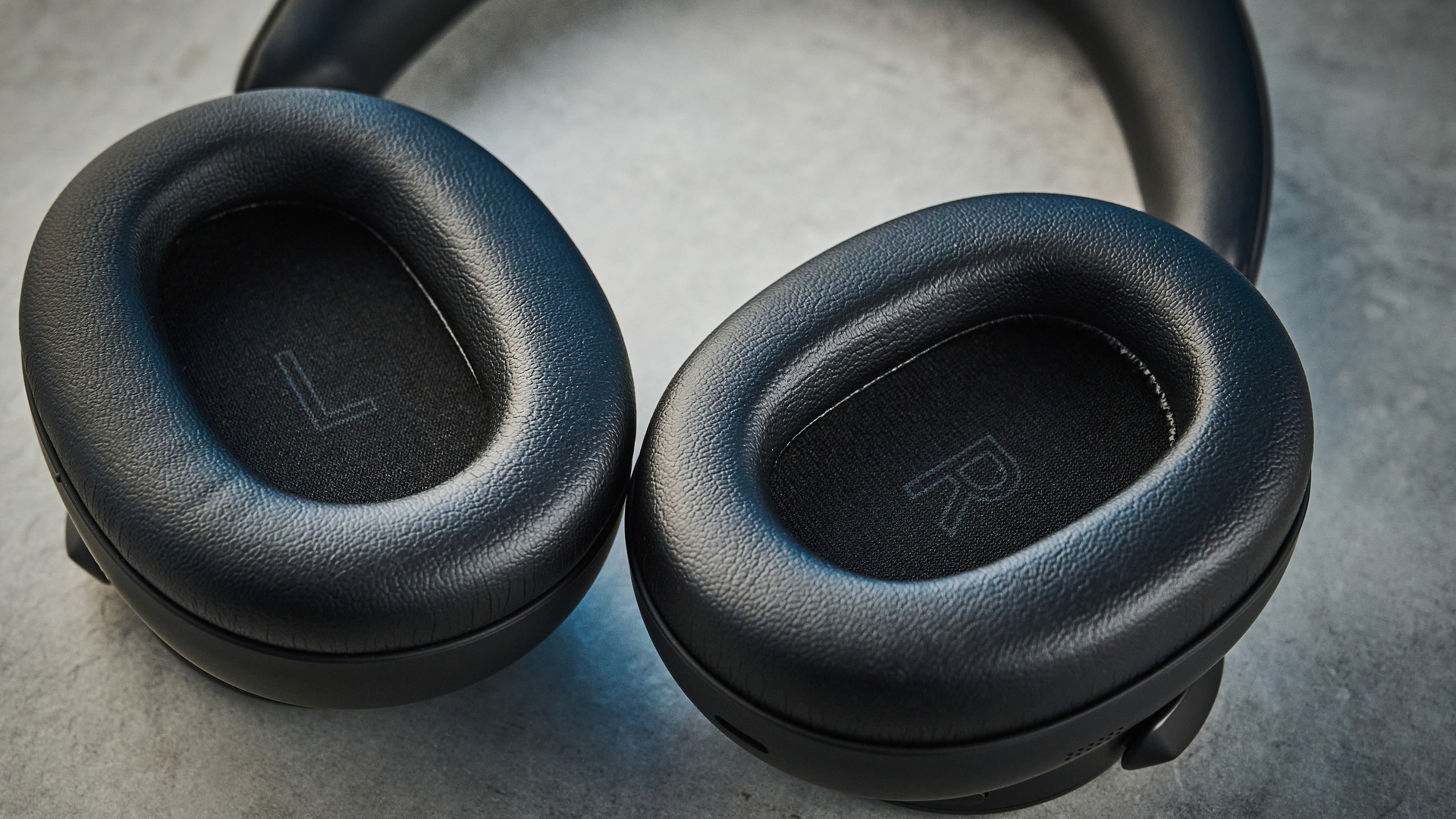 the technics eah-a1000 headphones with a gold technics logo photographed against a blue background