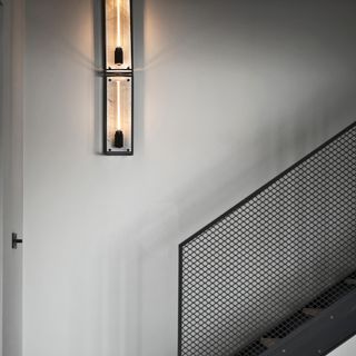 A buster and punch wall light on staircase