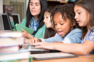 Elementary-age children learn computer coding in school