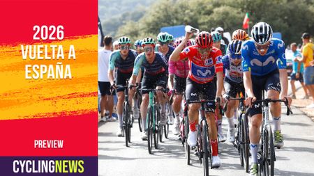 SIERRA DE LA PANDERA, SPAIN - SEPTEMBER 05: Enric Mas of Spain and Movistar Team - Red Leader Jersey (C) refreshes climbing to the Sierra de la Pandera (1816m) while fans cheer during the La Vuelta - 81st Tour of Spain 2026, Stage 14 a 154.5km stage from Jaen to Sierra de la Pandera 1816m / #UCIWT / on September 05, 2026 in Sierra de la Pandera, Spain. (Photo by Luis Gomez - Pool/Getty Images)
