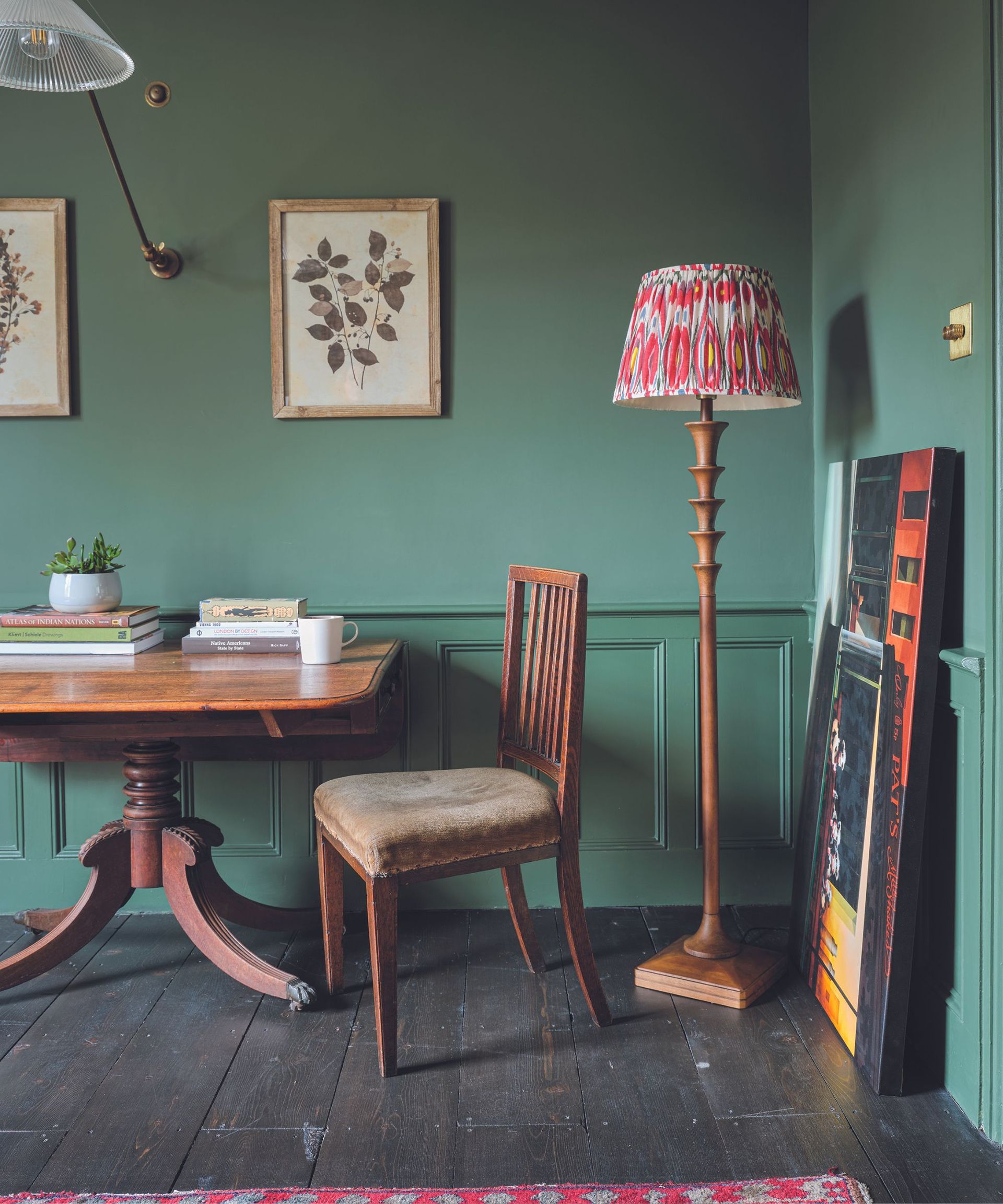 A green room with a tall artistic lamp