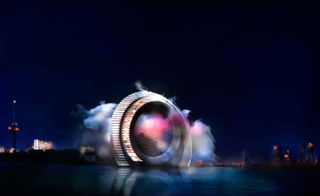 A digital image of the Dutch wind wheel building formed of two rings, photographed at night from a distance across the river