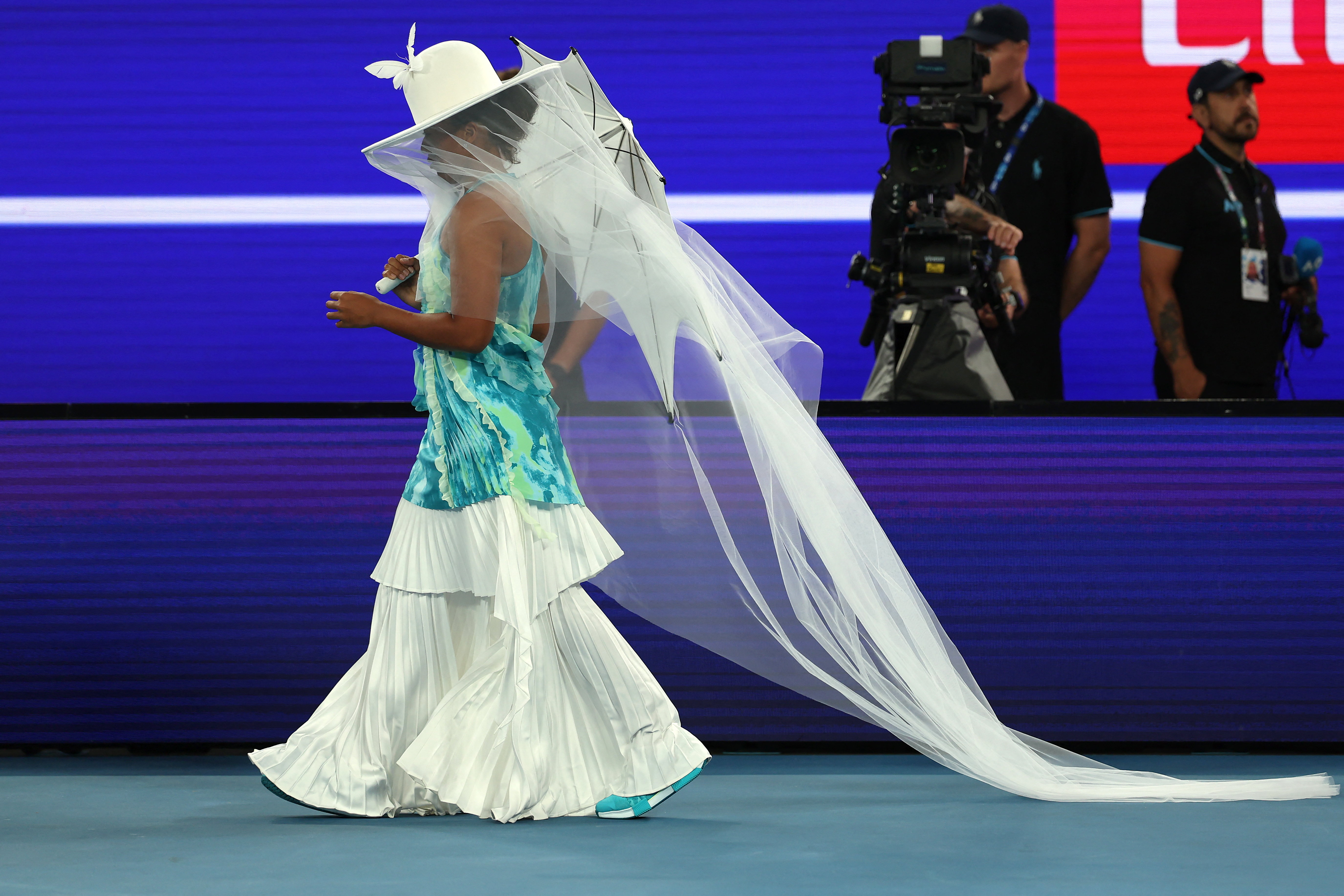 Naomi Osaka arrived at the 2026 Australian Open in a Robert Wun hat and umbrella, before revealing her tie-dye Nike athleisure