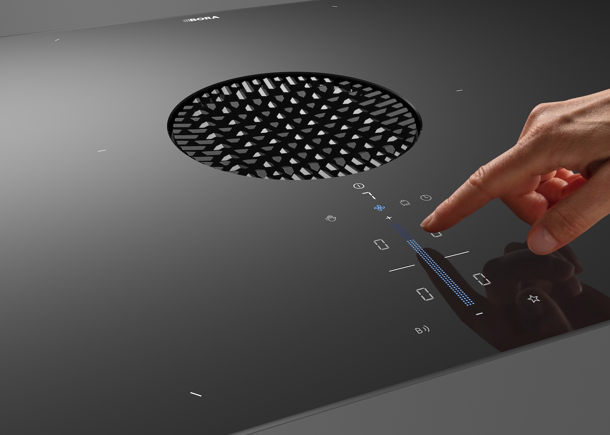 hand adjusting the controls on a hob