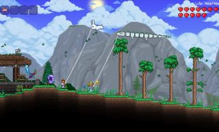 Terraria - Two players fly kites next to one another.