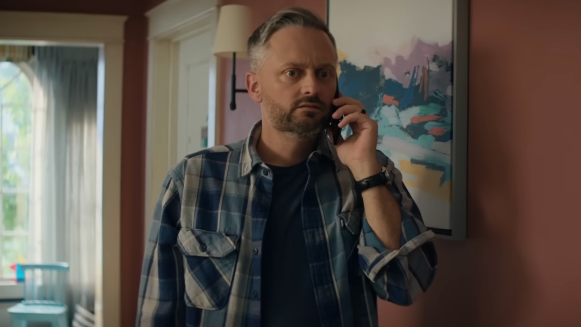 Nate Bargatze as Nate in The Breadwinner. He's on the phone with his wife and wearing a flannel shirt.