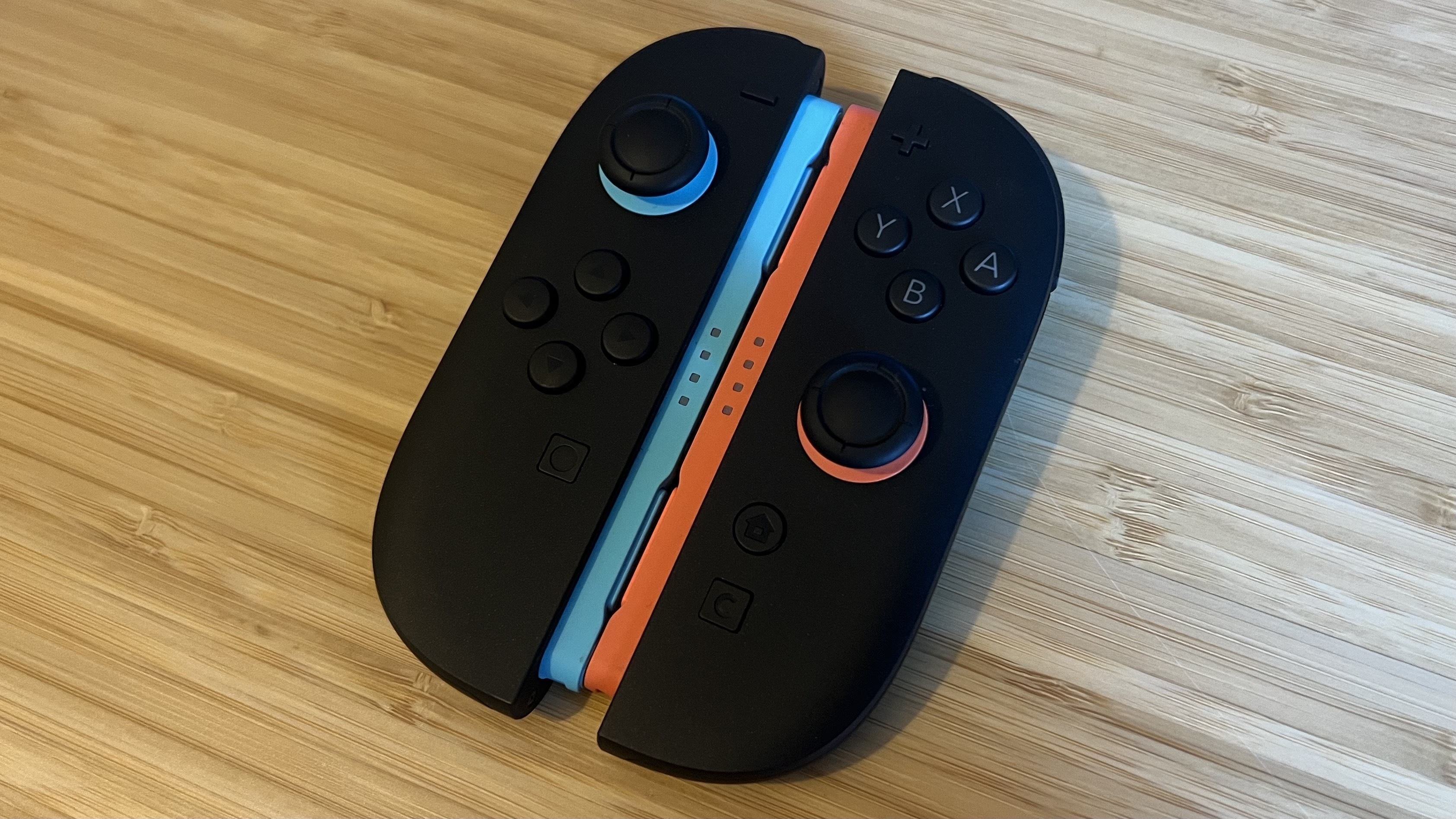 Nintendo Switch 2 Joy-Con pair on a wooden desk