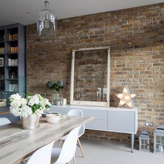 brick wall dinning table with chair and flower pot with bulb
