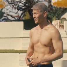 A shirtless man (Matthew Kim as Woosh) stands on a tennis court, in episode 202 of 'Beef.'