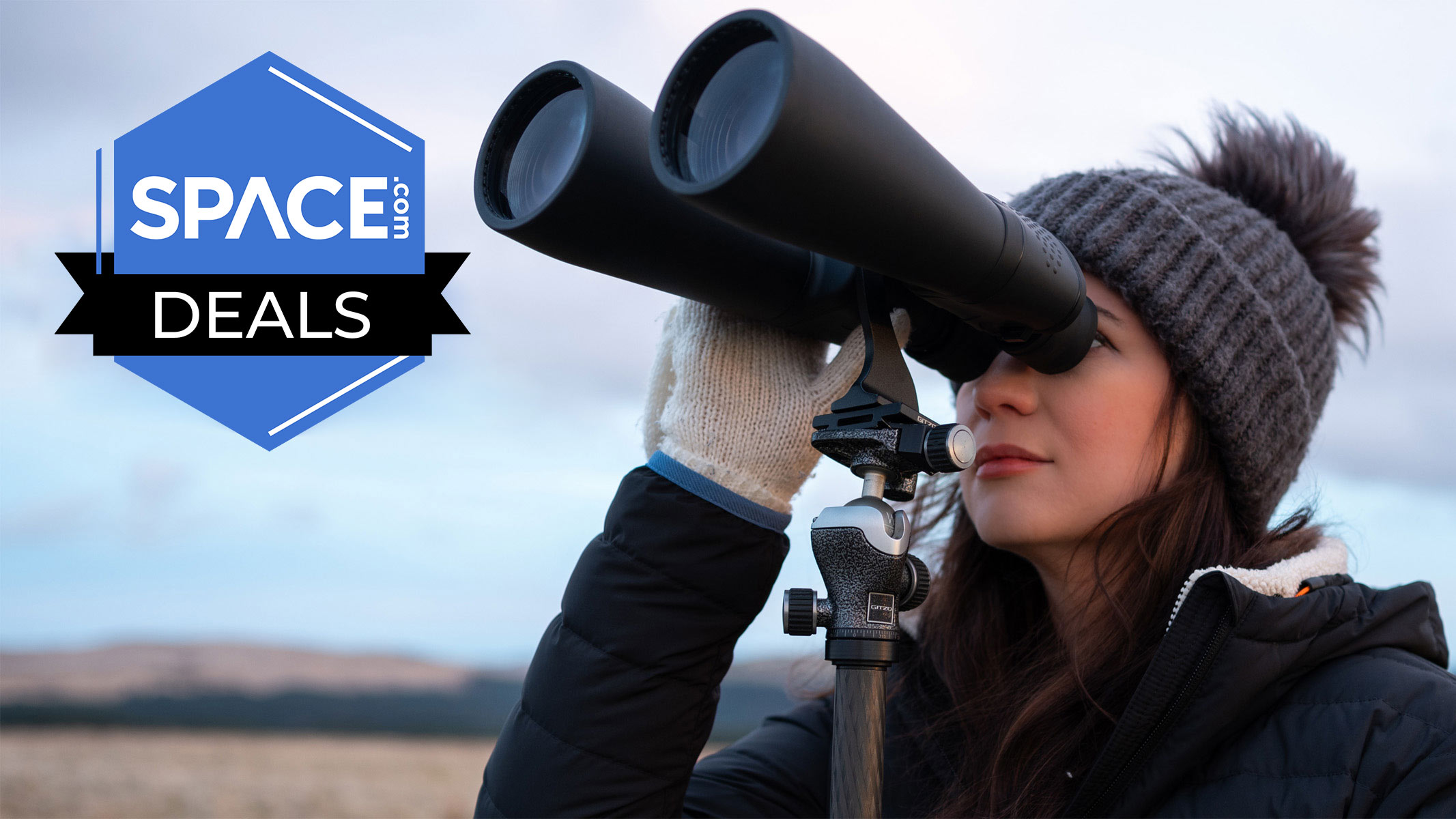Skywatching writer Kimberley Lane holds the Celestron Skymaster 15x70 binoculars on a tripod